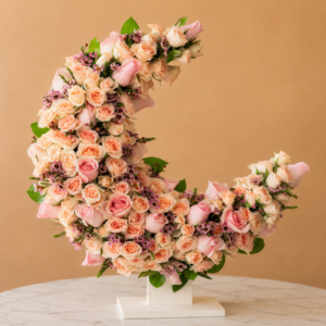 Shades Of Pink Crescent floral arrangement featuring 30 pink roses and 10 pink spray roses on a crescent moon stand, luxury pink floral display in Dubai for Eid, birthdays and anniversaries.