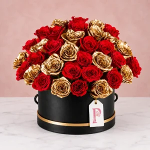 Luxury rose gold color and red roses hatbox arrangement featuring 20 red roses and gold sprayed stems in a premium black box, elegant romantic floral gift for special occasions.