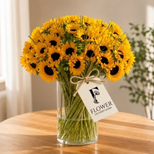 Sunflowers in a Glass Vase arrangement featuring 5 fresh-cut sunflowers with lush green fillers in a clear glass cylinder vase, perfect sunflower bouquet for bright mood floral gift delivery in Dubai.