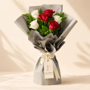 Red and white rose bouquet with fresh green fillers and elegant wrapping in Dubai